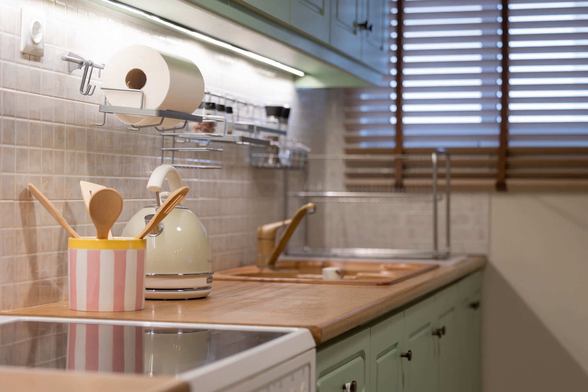 Kitchen sink, kettle and utensils by the window