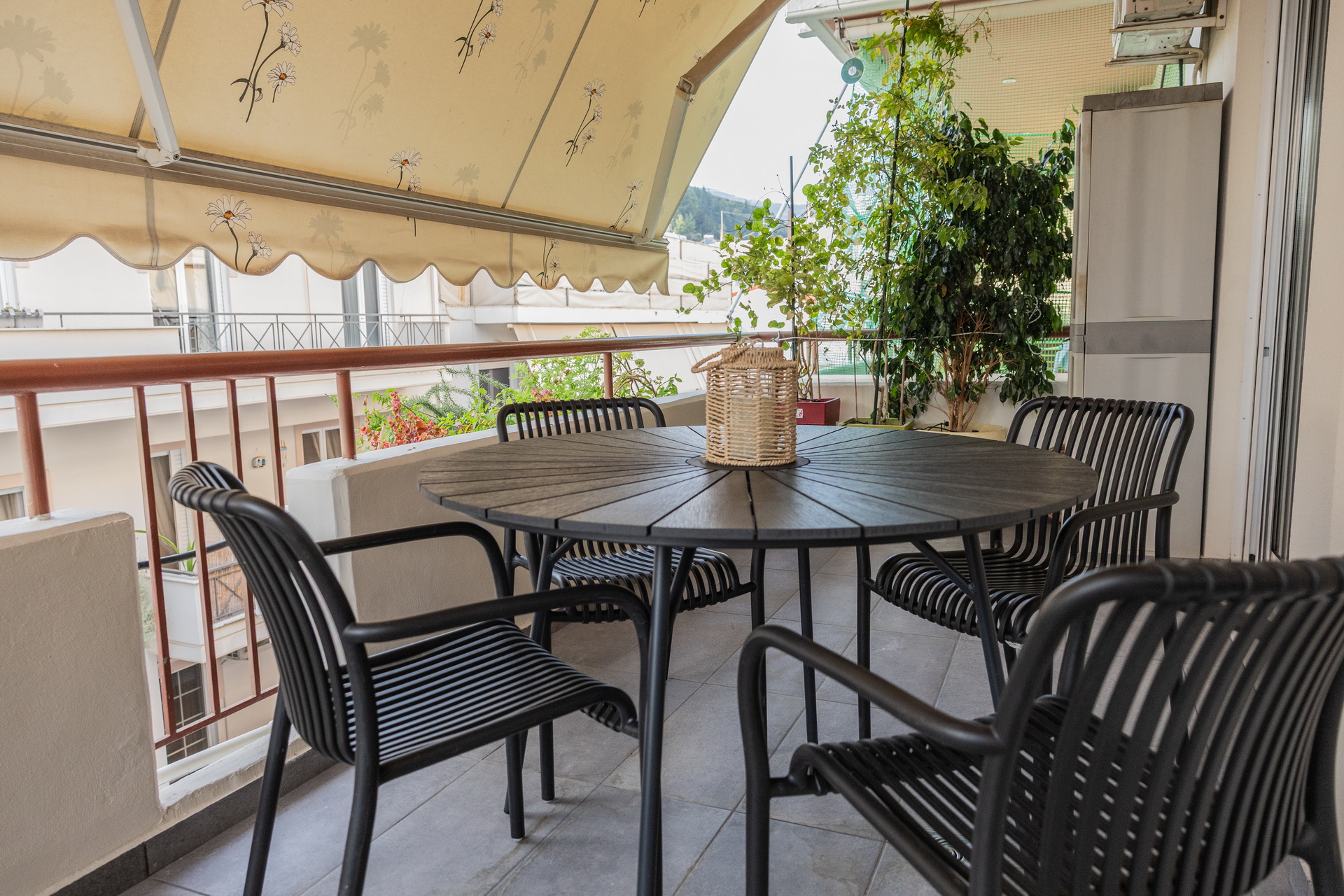 Shaded balcony table with four chairs