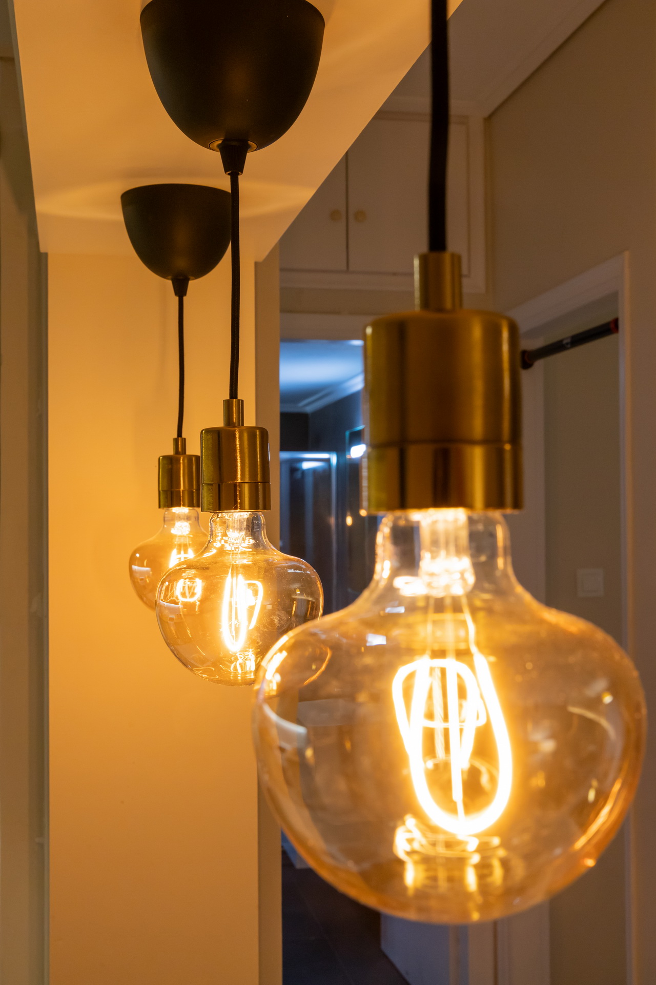 Brass pendant lights with warm filament bulbs