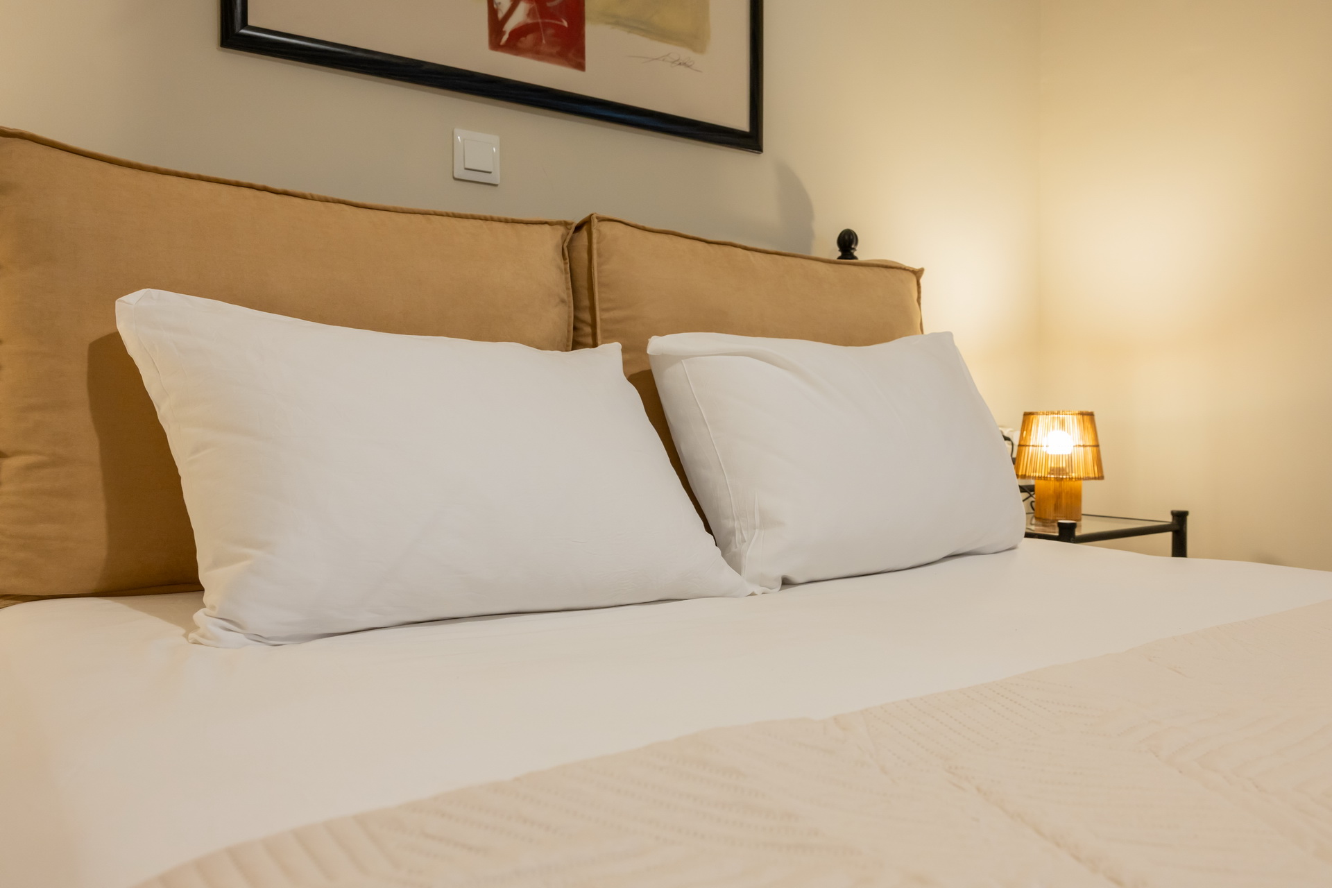 Fresh linen and bedside lamp